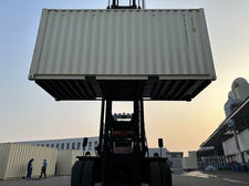 Shipping containers being transported by forklift