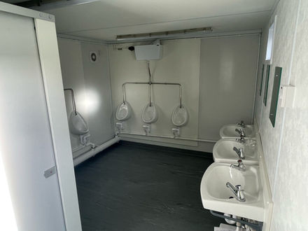 Internal view of cabin with urinals and sinks