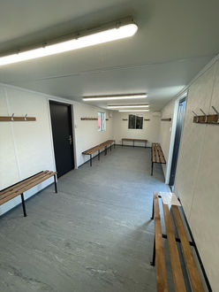 Internal view of new cabin with benches at either side 