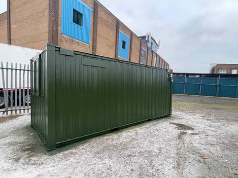 Exterior side view of green cabin 