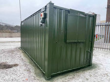 Exterior view of green cabin 